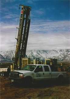 WM Blain pickup truck in front of a well drilling rig